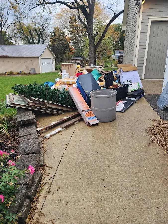 Dumpster being loaded with debris for Commercial Dumpster Rental in Wilkes-Barre